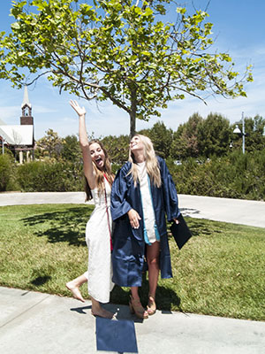 Amanda & Friend tossing their caps